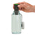 a hand holds the steripen adventurer in a bottle of water with the uv light on