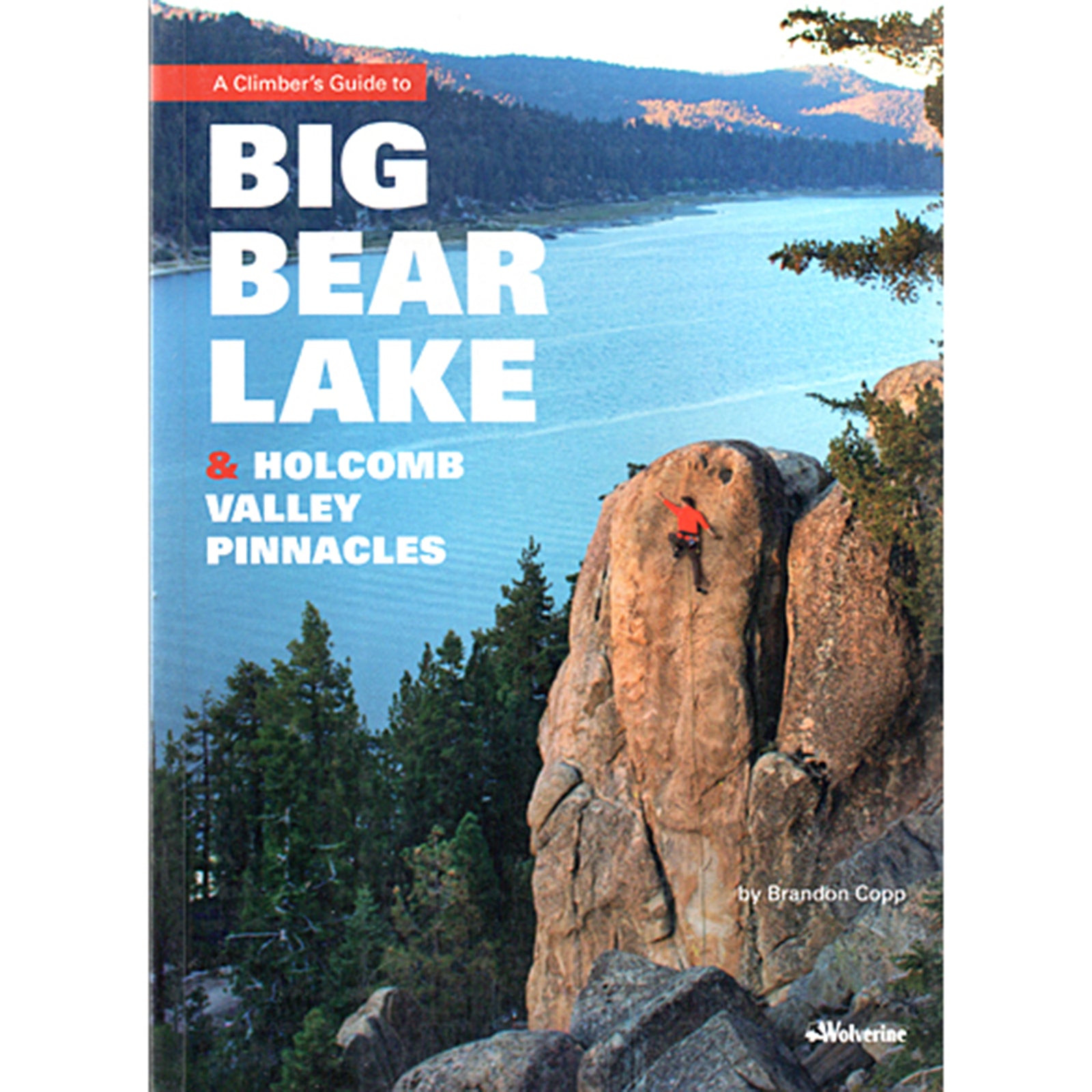 a person climbs a rock tower above Big Bear lake, on the cover of the Big Bear Lakes climbing guide