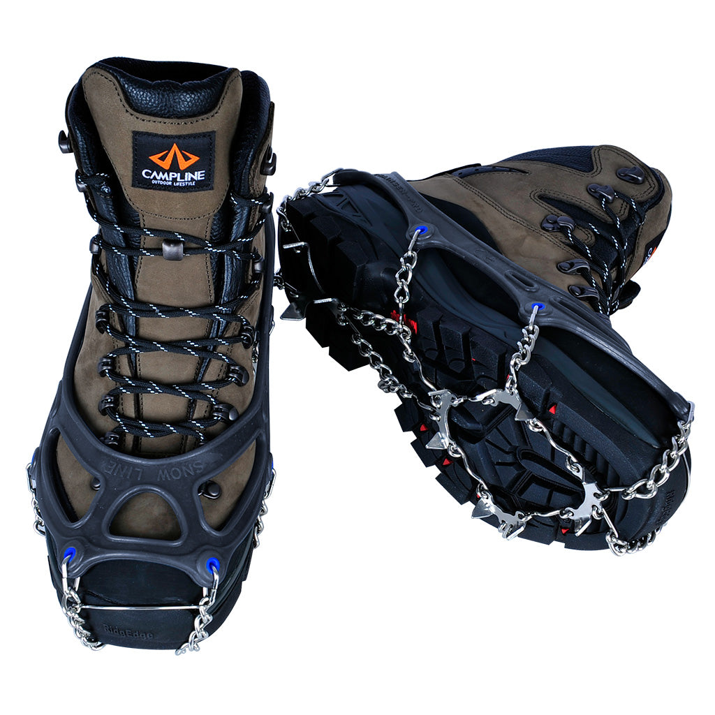 a pair of boots wearing the chainsen pro crampon showing the toe of one boot and the sole of the other