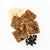 Four pieces of the oatmeal chocolate chip probar cut into square pieces with some of the raw ingredients