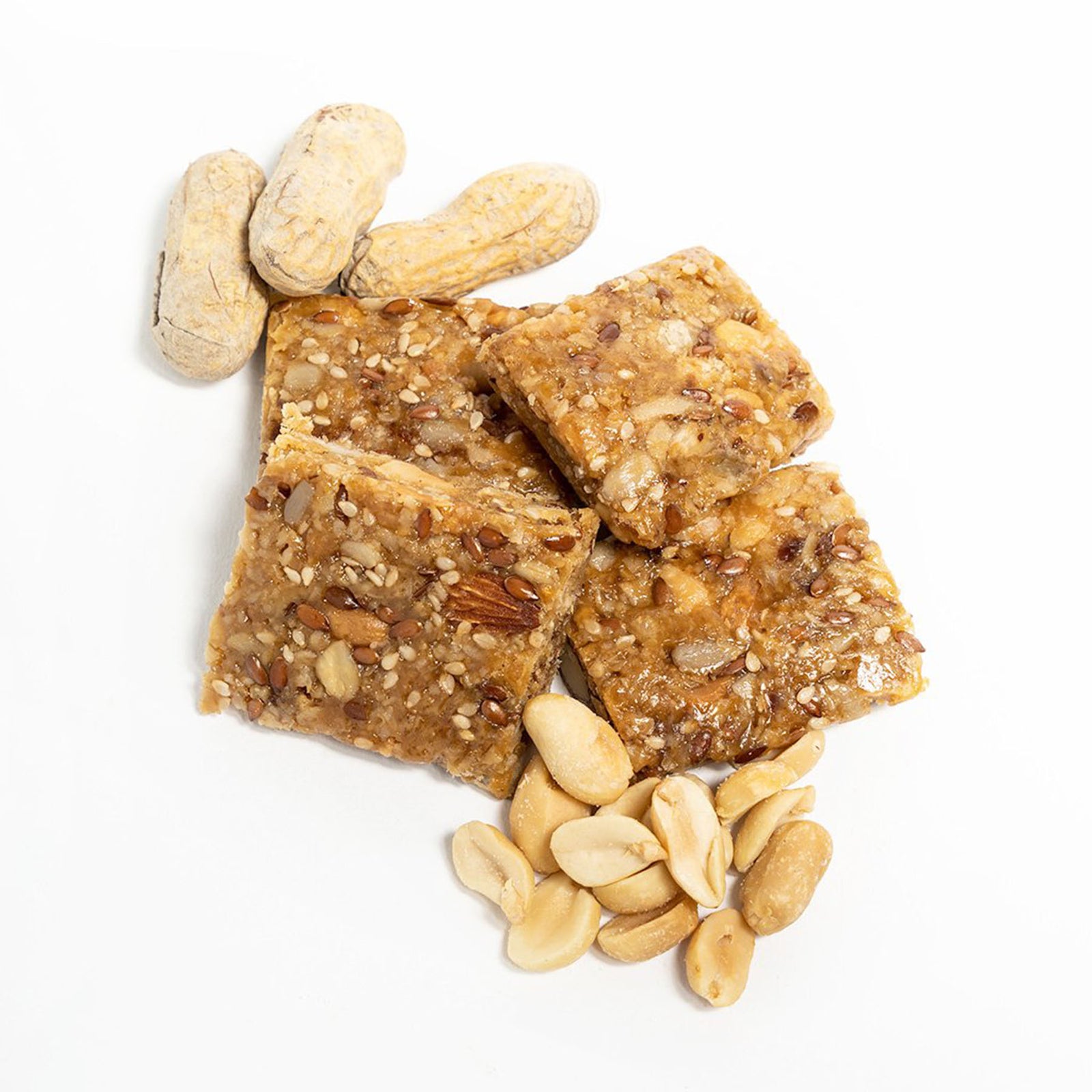 four square pieces of peanutbutter probar with some of the raw ingredients