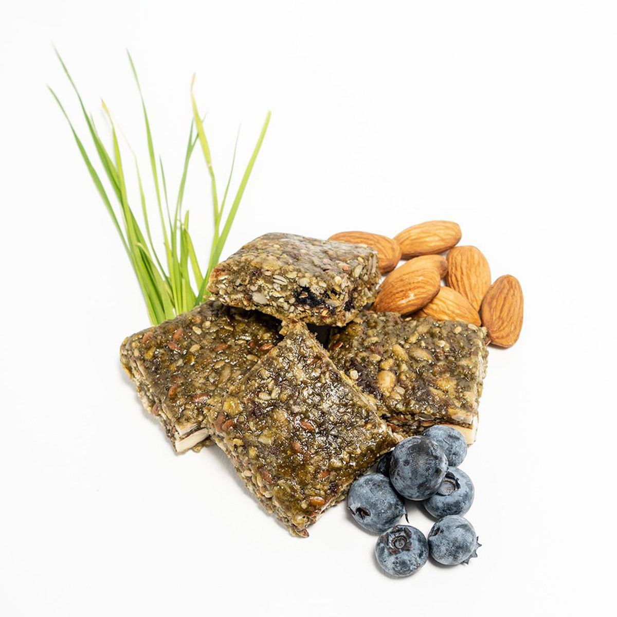 four squares of the super berry and greens probar along with some of their constituent indgredients