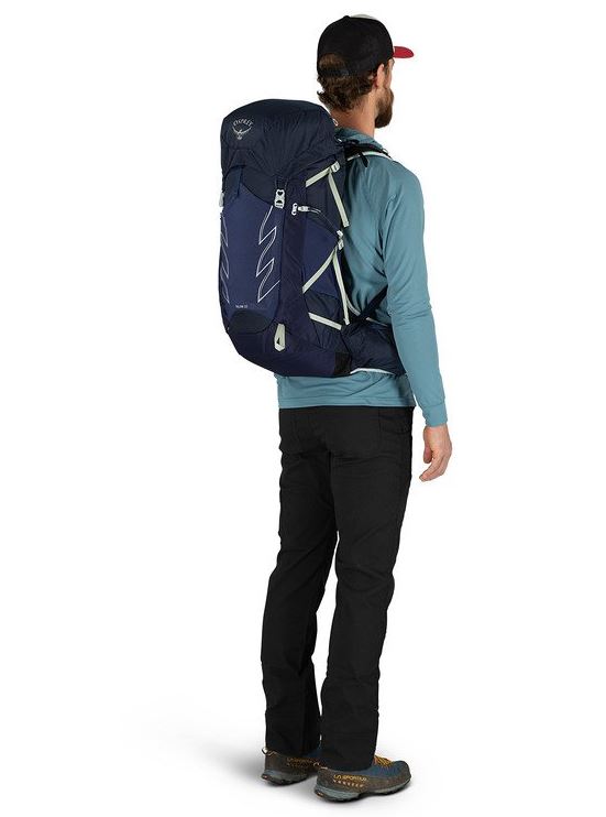 osprey talon 33 pack in ceramic blue on a model, back view