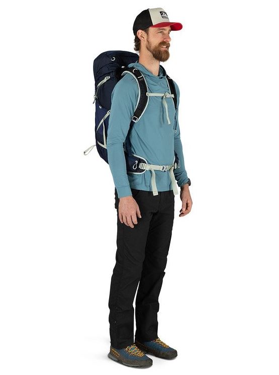 osprey talon 33 pack in ceramic blue on a model, front view