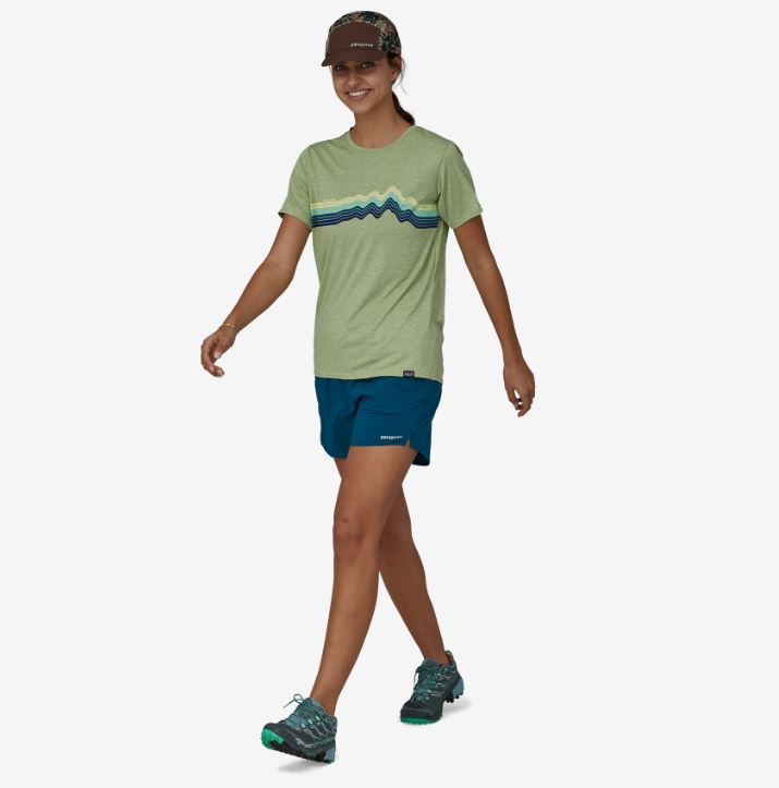 a photo of the patagonia womens multi trails shorts with a five and a half inch inseam in the color lagom blue, front view on a model while walking