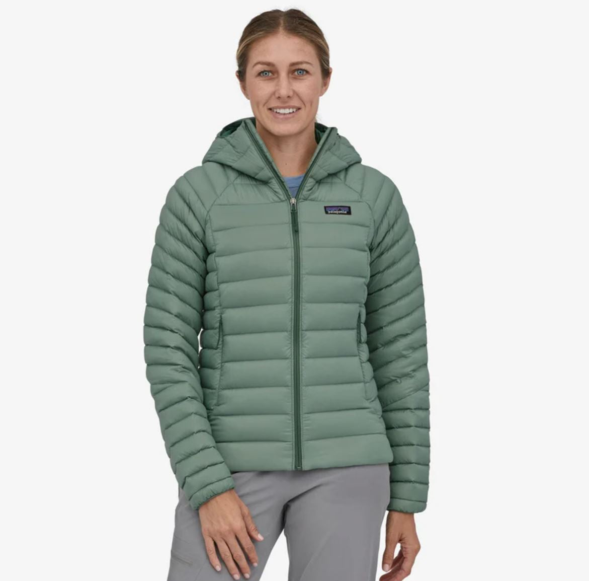 patagonia womens down sweater hoody in hemlock green, front view on a model