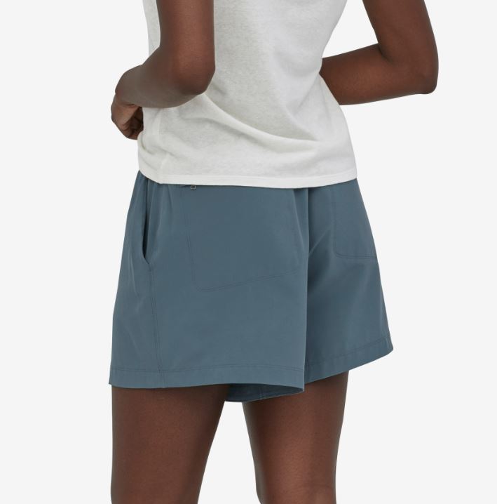 a photo of the patagonia womens fleetwith short in the color plume grey, back view on a model