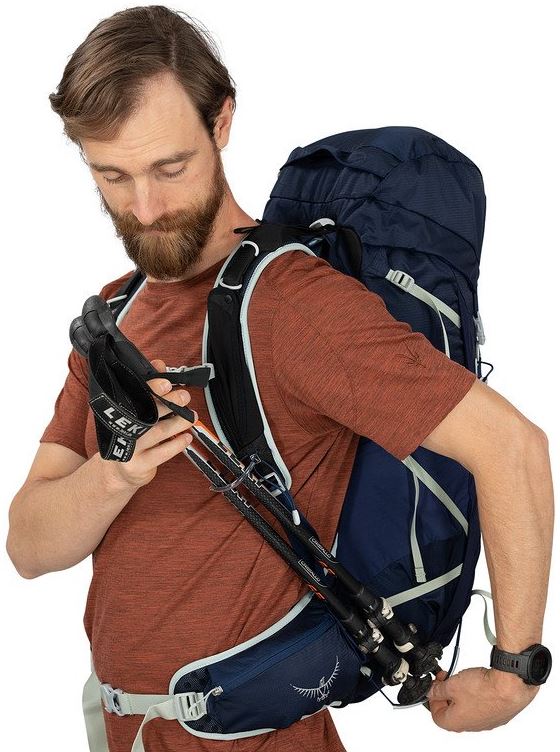 osprey talon 33 pack in ceramic blue on a model, side view