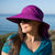 a photo of the women's sundancer hat on a model, in the color amethyst